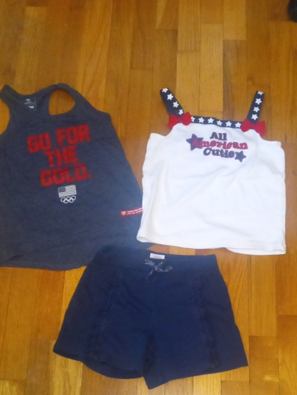 girl med blue shorts, and two tanks red white blue